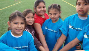 GOS Donation 01 San Filipe Pueblo NM Gear Delivery - Kids on Field at Indian Pueblo