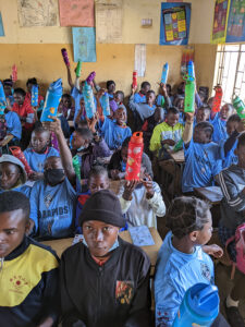 GOS Donation 19 Zambia Gear Delivery - Kids Receiving Soccer Gear in Classroom