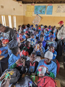 GOS Donation 19 Zambia Gear Delivery - Kids Receiving Soccer Gear in Classroom