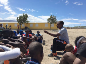 GOS Donation 13 Haiti Gear Delivery - Kids Getting Instruction