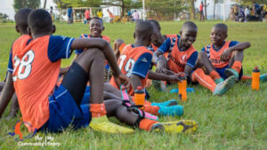 Gift of Soccer Donations to Young Adults Around the World - team laughing on the grass