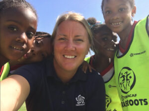 Gear Delivery - UNM Womens Head Coach Heather Dyche delivering Gift of Soccer Gear