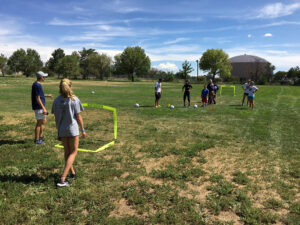 GOS Gear Volunteering - Kenny and Jessie from the Gift of Soccer Foundation Team running local soccer camps