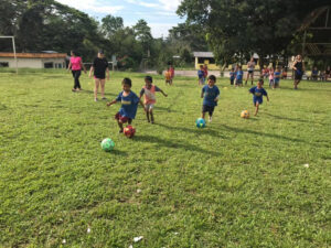 GOS Donation 15 Ecuador Gear Delivery - Kids Playing Soccer on Grass